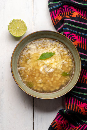 Traditional mexican corn grain boiled also called esquites with cheese and mayonnaise on white backgroundの写真素材