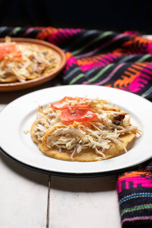 Traditional mexican salbutes with shredded chicken on white backgroundの写真素材