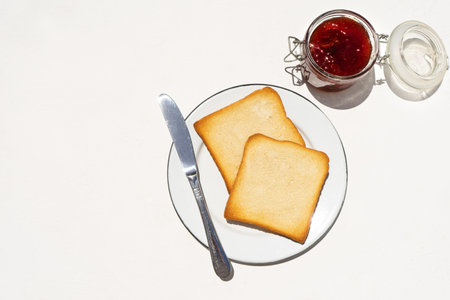 Bread toast and strawberry jam on white background