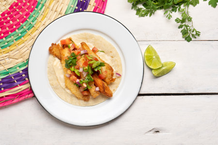 Traditional mexican breaded fish tacos also called ensenada on white backgroundの写真素材
