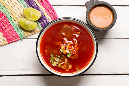 Traditional mexican beef birria consomme on white backgroundの写真素材