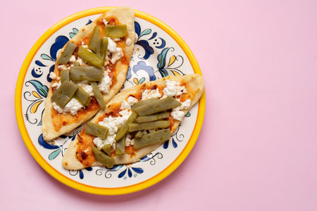 Traditional mexican tlacoyos with nopal cactus and cheese on pink backgroundの写真素材