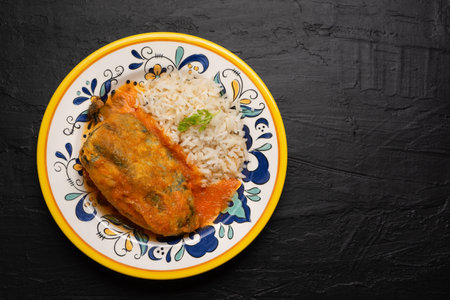Traditional mexican chili-stuffed poblano with rice on dark backgroundの写真素材