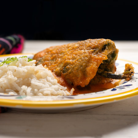 Traditional mexican chili-stuffed poblano with rice on white backgroundの写真素材