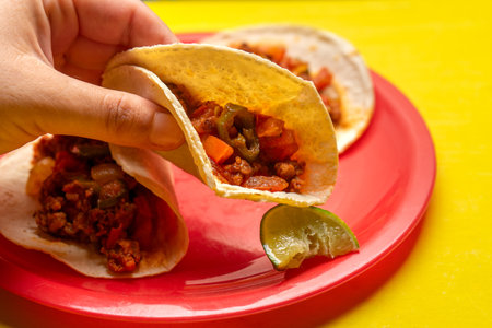 Traditional mexican chorizo tacos on yellow backgroundの写真素材