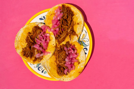 Traditional mexican cochinita pibil tacos with onion on pink backgroundの写真素材