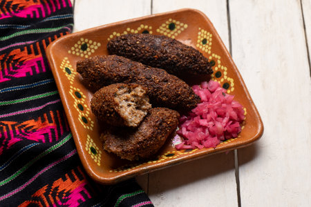 Traditional mexican kibi with meat and onion on white backgroundの写真素材