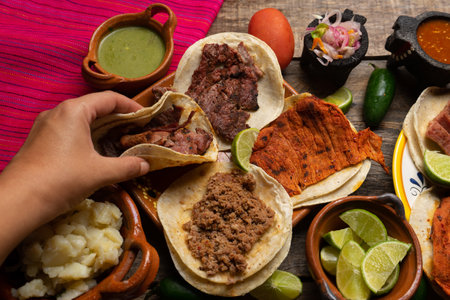 Assortment of traditional mexican tacos on wooden background
