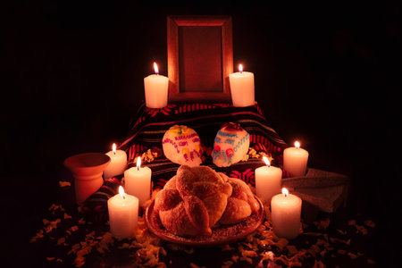 Traditional mexican day of the dead altar with bread and sugar skulls on dark backgroundの写真素材