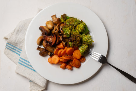 Traditional roasted vegetables in plate on white backgroundの写真素材