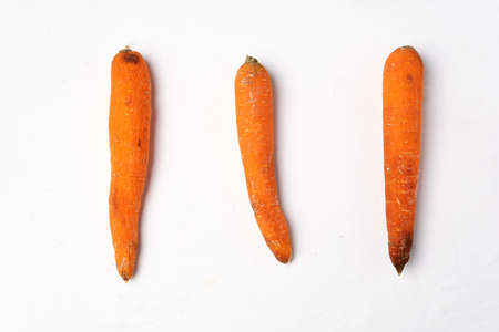 Rotten carrots vegeable on white backgroundの写真素材