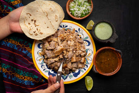 Confit pork called carnitas on dark background. Traditional mexican foodの写真素材