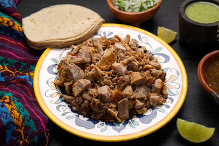 Confit pork called carnitas on dark background. Traditional mexican foodの写真素材