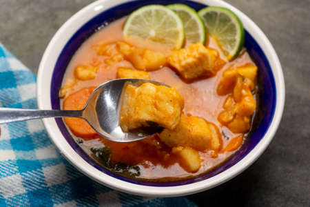 Fish soup with vegetables on gray background. Traditional mexican foodの写真素材