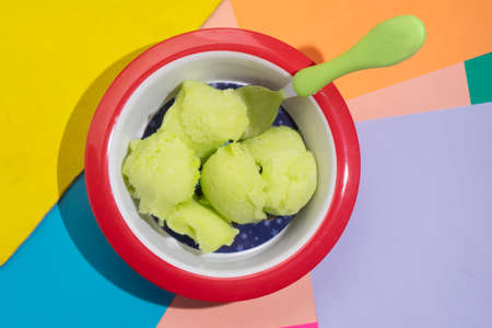 Green lime snow ice cream on colorful backgroundの写真素材