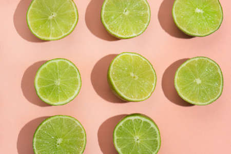 Cutted green lime on pink backgroundの写真素材