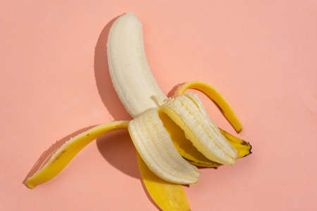 yellow banana fruit on pink backgroundの写真素材