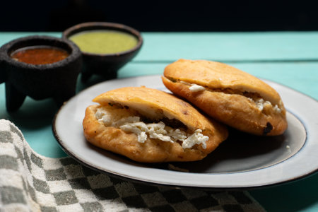 Chicharron gorditas with cheese on turquoise background. Traditional mexican foodの写真素材