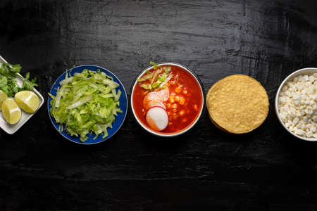 Traditional mexican food. Red pozole with chicken on dark backgroundの写真素材