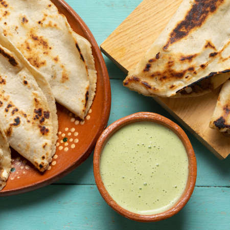 Traditional mexican food. Quesadillas with meat on turquoise backgroundの写真素材