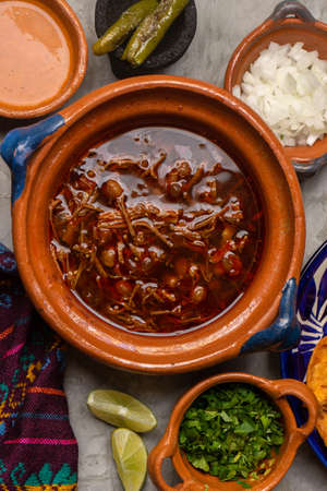 Beef birria with chickpeas on a gray background. Traditional mexican food