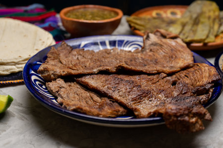Beef steak called tampiqueÃ±a with cactus and onion on a gray background. Traditional mexican foodの写真素材
