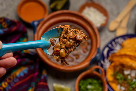 Beef birria with chickpeas on a gray background. Traditional mexican food