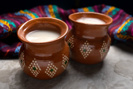 Traditional mexican fermented beverage called pulque on a gray backgroundの写真素材
