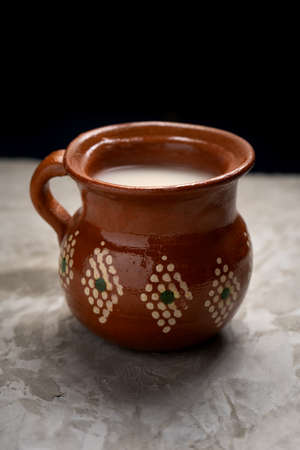 Traditional mexican fermented beverage called pulque on a gray background