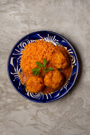 meatballs with red rice and tomato broth on a gray background. Traditional mexican foodの写真素材