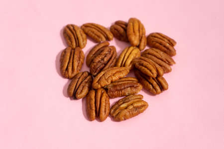 Peeled walnuts on a pink backgroundの写真素材