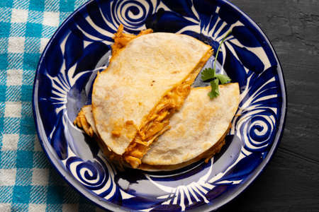 Chicken tinga quesadilla with flour tortilla. Traditional mexican food