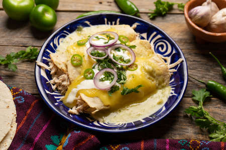Traditional mexican green enchiladas with chicken and melted cheeseの写真素材