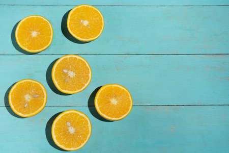 Fresh orange halves on turquoise backgroundの写真素材
