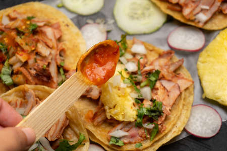 Pork tacos called al pastor with pineapple and sauce. traditional mexican foodの写真素材