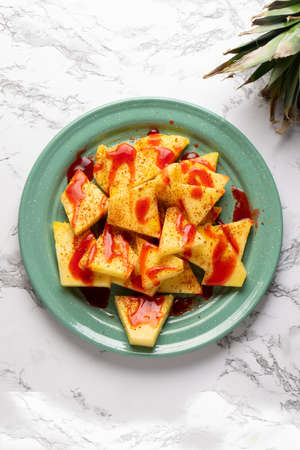 Pineapple fruit with chili powder and chamoy. mexican foodの写真素材