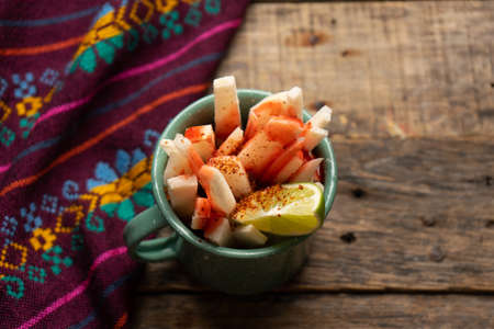 Cutted mexican yam bean also called Jicama with chili powder and chamoy sauceの写真素材