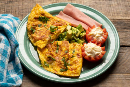 Healthy ham omelette with avocado and tomato