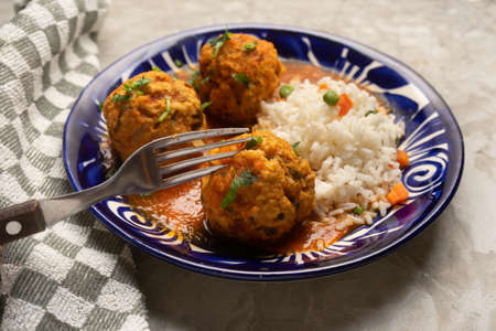 Meatballs with chipotle red sauce and rice. traditional mexican food