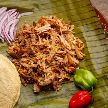 Cochinita pibil in banana leaves with habanero peppers. traditional mexican foodの写真素材