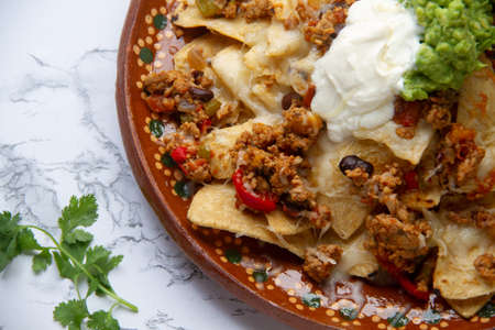 Nachos with guacamole and chilli con carne. traditional mexican foodの写真素材