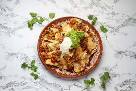 Nachos with guacamole and chilli con carne. traditional mexican foodの写真素材