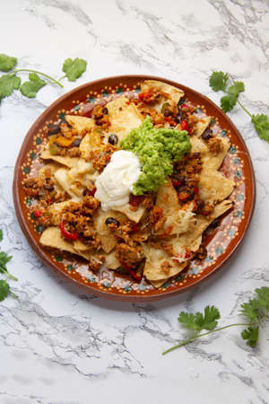 Nachos with guacamole and chilli con carne. traditional mexican foodの写真素材