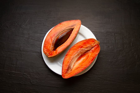 Traditional mexican fruit called mamey on dark backgroundの写真素材