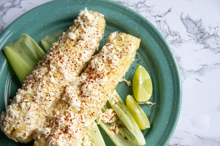 Mexican street food; Elotes with mayonnaise, cheese and chili powderの写真素材