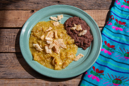 Mexican traditional food; Chicharron with green sauce and refried beansの写真素材