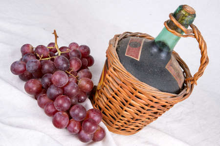 Old Decanter of Red Wine with Grapesの写真素材