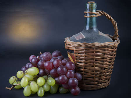 Old Decanter of Red Wine with Grapesの写真素材