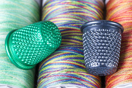 Spools and Metallic Thimbles  Colored Texture Macro  の写真素材