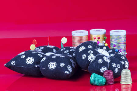 Neddle Case, Spools and Thimbles Isolated on Red の写真素材